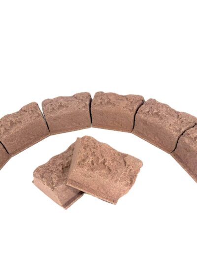 Partial circle of rough brown stones arranged end-to-end on a white background, like a rock ring