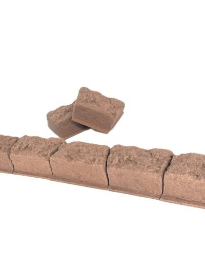 Row of brown bricks with rough texture aligned along the bottom on a white background.